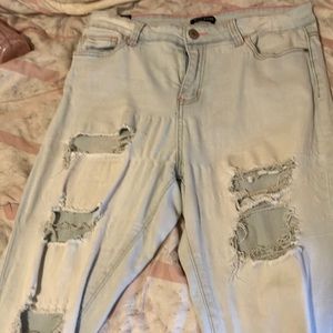 Light blue skinny ripped Jean with pink lining around the waist.